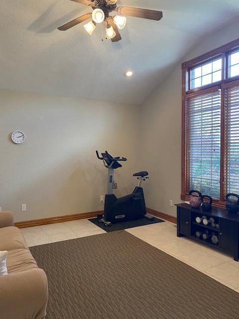4822 S Montrose Pl, Springfield, MO 65810 - exercise room featuring vaulted ceiling, a ceiling fan, light tile patterned flooring, and baseboards