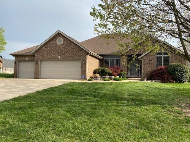 4822 S Montrose Pl, Springfield, MO 65810 - single story home featuring brick siding, an attached garage, driveway, and a front yard
