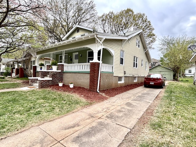 535 E Normal St, Springfield, MO 65807 - view of front facade with a porch, a front lawn, a garage, and an outdoor structure