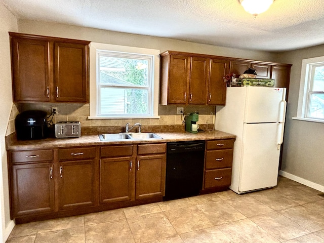 535 E Normal St, Springfield, MO 65807 - kitchen featuring black dishwasher, freestanding refrigerator, backsplash, and a textured ceiling