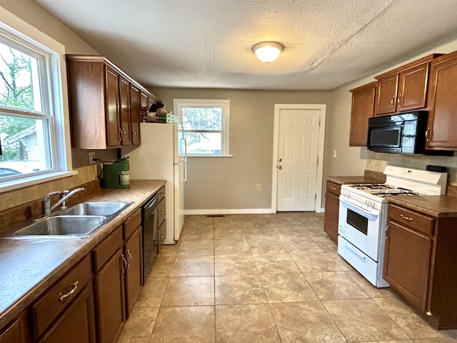 535 E Normal St, Springfield, MO 65807 - kitchen with black appliances, dark countertops, light tile patterned floors, and a textured ceiling