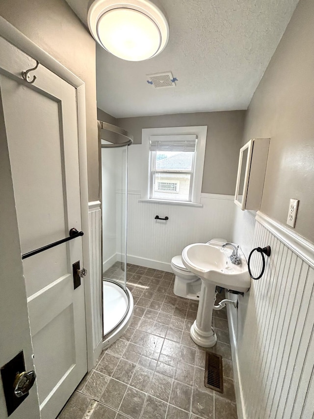 535 E Normal St, Springfield, MO 65807 - bathroom with a wainscoted wall, a shower stall, and a textured ceiling