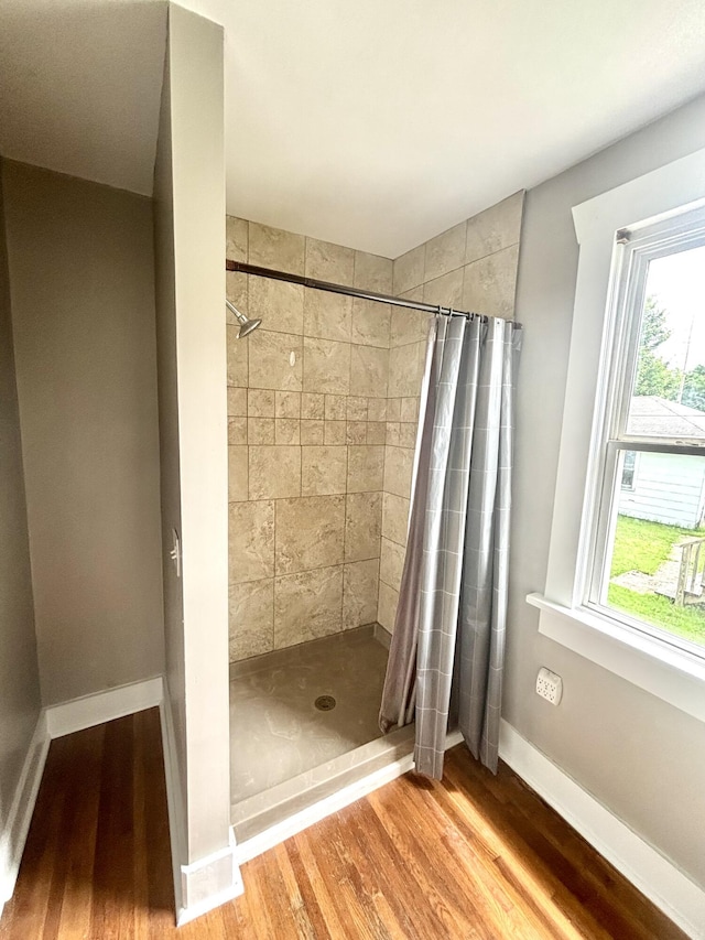 535 E Normal St, Springfield, MO 65807 - full bathroom featuring wood finished floors, a shower stall, and healthy amount of natural light