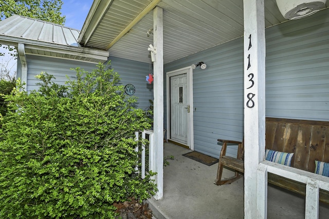view of exterior entry with a porch
