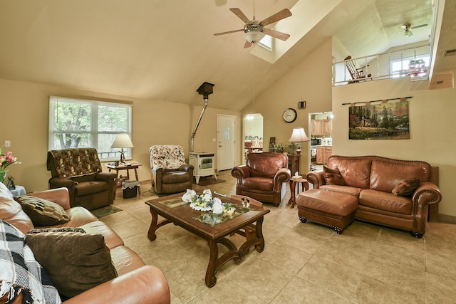 living room with high vaulted ceiling, a ceiling fan, and plenty of natural light