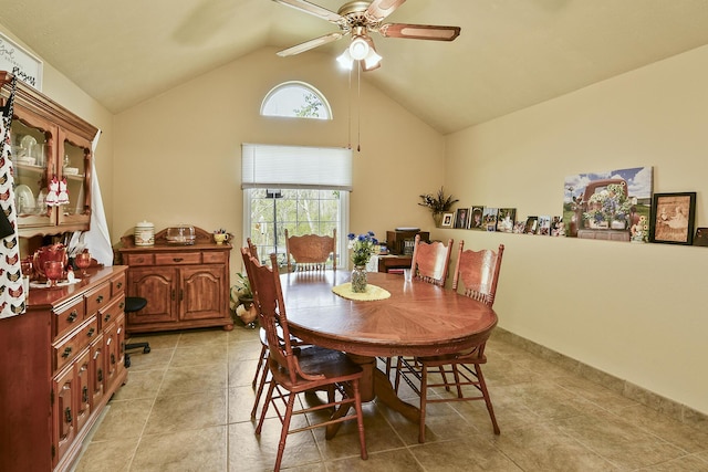 dining room featuring high vaulted ceiling, ceiling fan, and light tile patterned floors