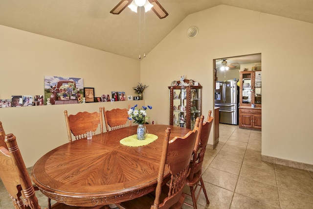 dining area featuring lofted ceiling, visible vents, light tile patterned floors, baseboards, and ceiling fan
