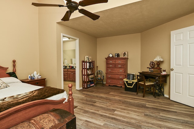 bedroom featuring a ceiling fan, wood finished floors, and ensuite bathroom