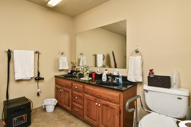 full bathroom featuring toilet, tile patterned flooring, a sink, and double vanity