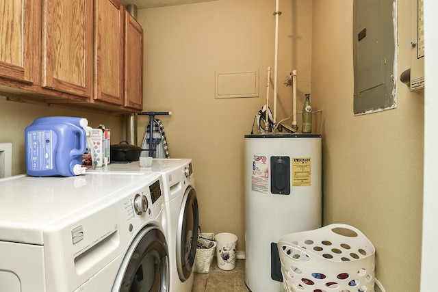 clothes washing area with tile patterned floors, electric panel, separate washer and dryer, cabinet space, and electric water heater