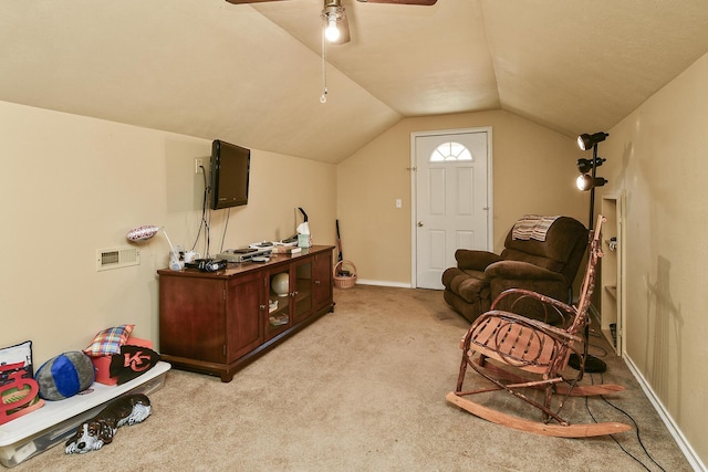 living area featuring ceiling fan, lofted ceiling, baseboards, and light carpet