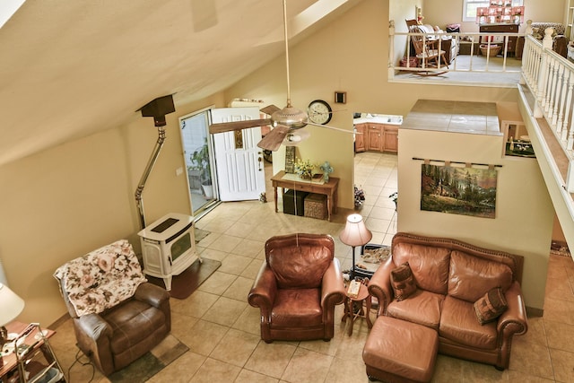 tiled living area with lofted ceiling, a ceiling fan, and heating unit