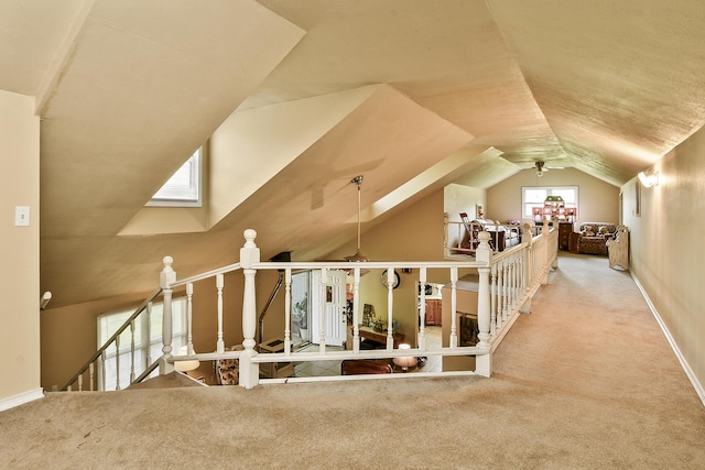 additional living space featuring ceiling fan, lofted ceiling, baseboards, and carpet