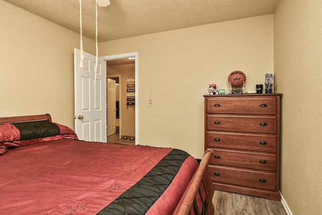 bedroom with baseboards and wood finished floors