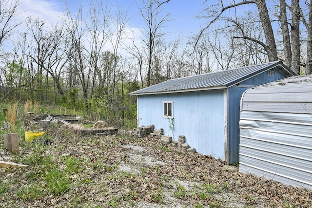 view of property exterior featuring an outbuilding