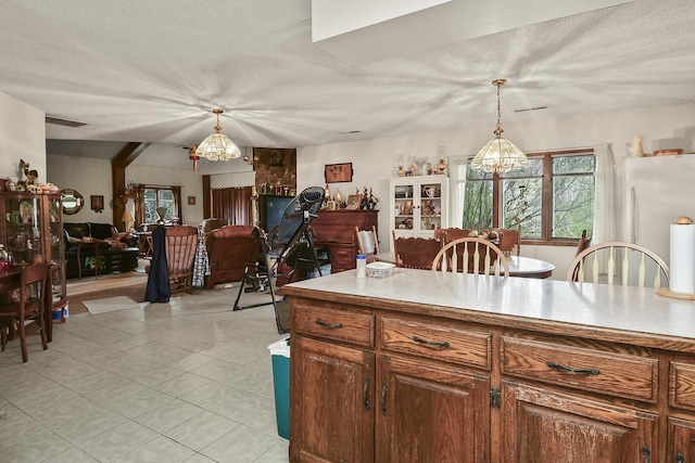 8100 Creek Rd, Hartville, MO 65667 - kitchen featuring pendant lighting, a chandelier, light countertops, and light tile patterned floors