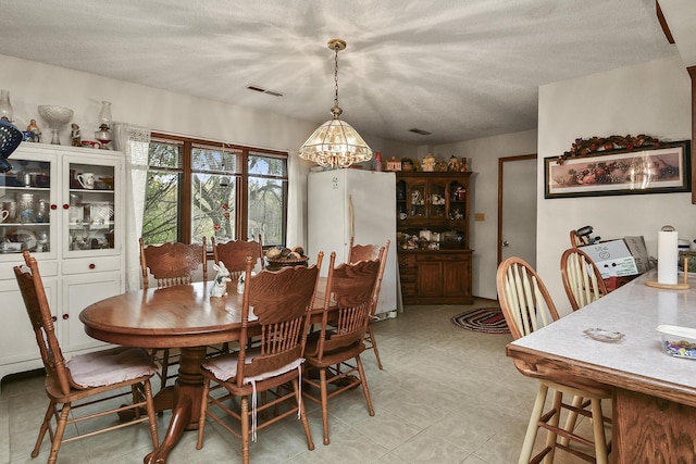 8100 Creek Rd, Hartville, MO 65667 - dining room featuring a chandelier, visible vents, and a textured ceiling