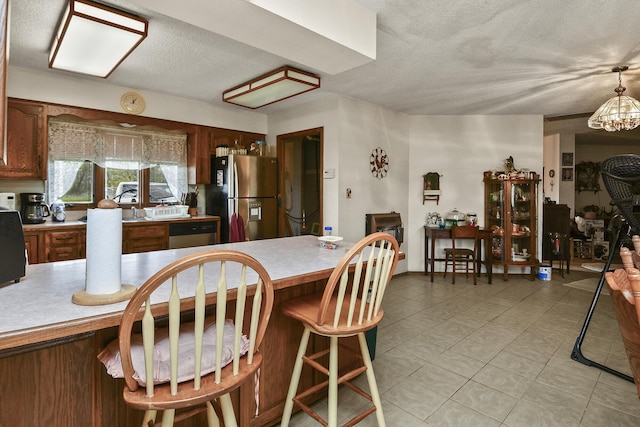 8100 Creek Rd, Hartville, MO 65667 - dining area with a chandelier, a textured ceiling, and light tile patterned floors