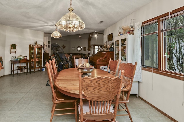 8100 Creek Rd, Hartville, MO 65667 - dining room with a textured ceiling, a wealth of natural light, and an inviting chandelier