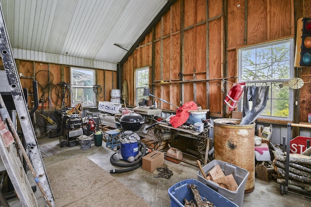 8100 Creek Rd, Hartville, MO 65667 - miscellaneous room featuring unfinished concrete flooring, vaulted ceiling, and a garage