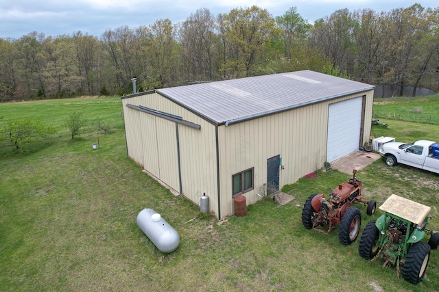 8100 Creek Rd, Hartville, MO 65667 - view of pole building featuring driveway, a view of trees, and a yard