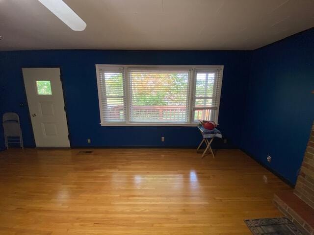 unfurnished room with light wood-type flooring