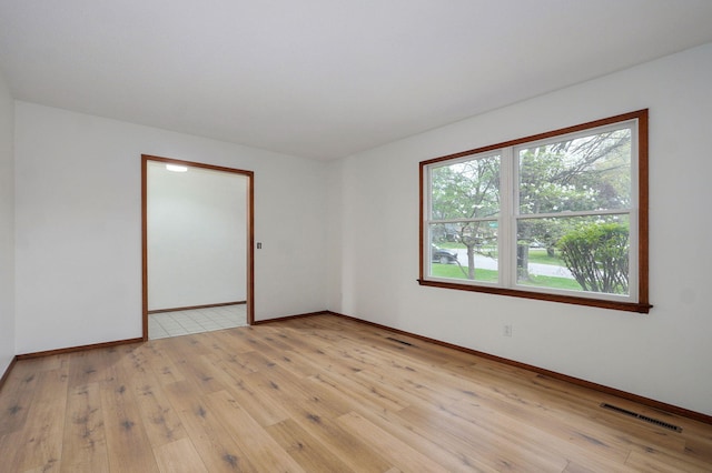 4542 S Holiday Ave, Springfield, MO 65810 - spare room with baseboards, light wood-style flooring, and visible vents