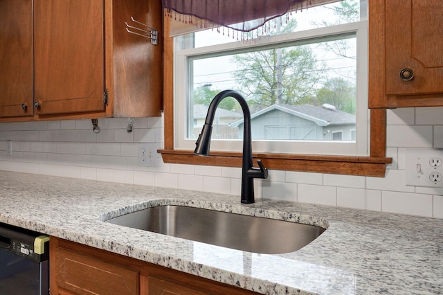 4542 S Holiday Ave, Springfield, MO 65810 - room details with black dishwasher, tasteful backsplash, brown cabinetry, and a sink