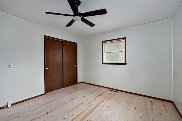 4542 S Holiday Ave, Springfield, MO 65810 - unfurnished bedroom featuring ceiling fan, baseboards, light wood-type flooring, and a closet