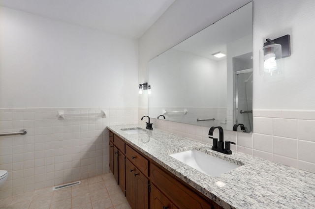 4542 S Holiday Ave, Springfield, MO 65810 - full bath featuring a stall shower, a sink, visible vents, and tile walls