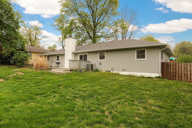 4542 S Holiday Ave, Springfield, MO 65810 - back of house featuring a lawn, a chimney, a deck, fence, and roof with shingles
