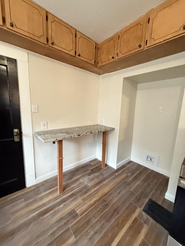 1001 E Pacific St, Springfield, MO 65803 - washroom with baseboards, laundry area, and dark wood finished floors