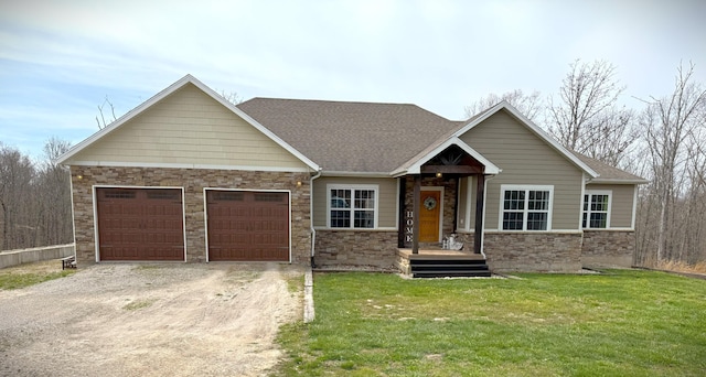 view of front facade with a front yard, an attached garage, stone siding, driveway, and roof with shingles