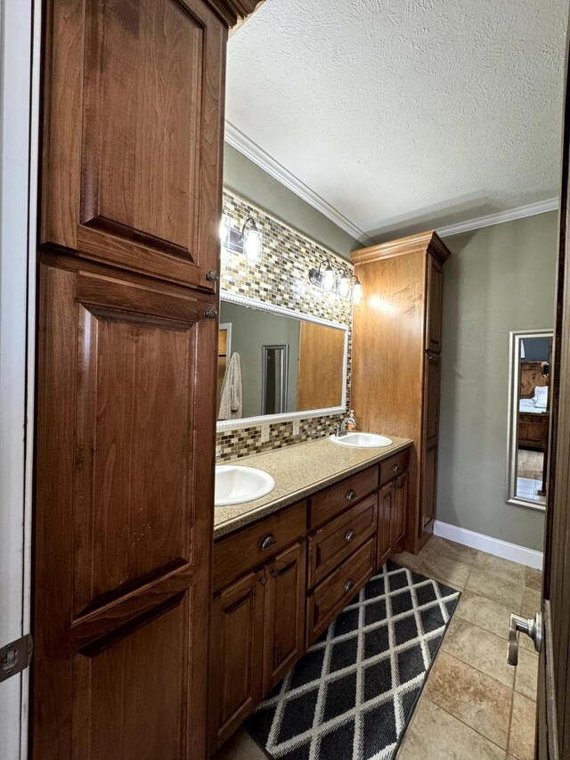 full bathroom featuring tasteful backsplash, double vanity, a sink, and ornamental molding