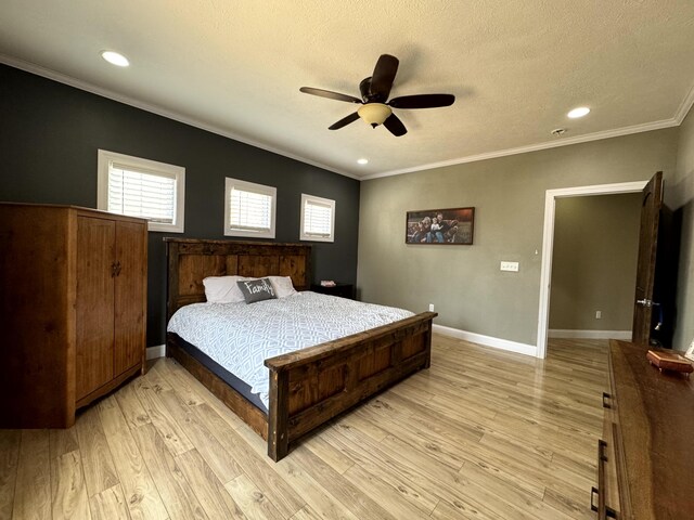 bedroom with light wood finished floors, baseboards, a textured ceiling, and crown molding