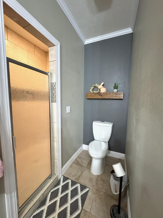 bathroom with a shower stall, ornamental molding, and toilet