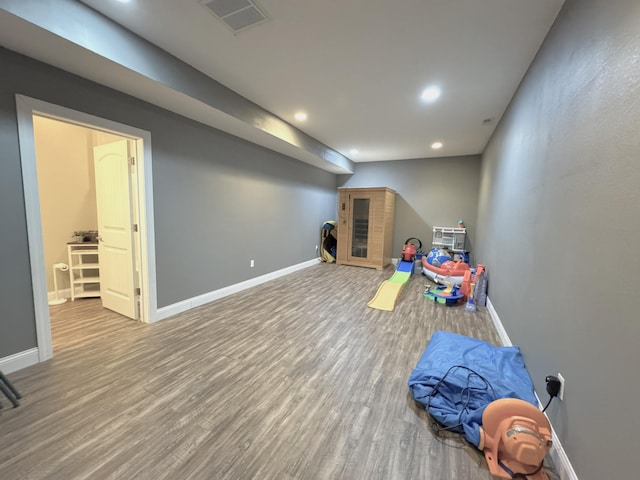 recreation room featuring baseboards, wood finished floors, visible vents, and recessed lighting