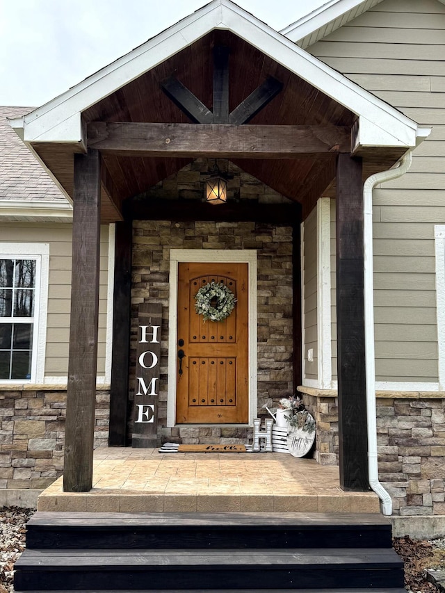 property entrance featuring stone siding