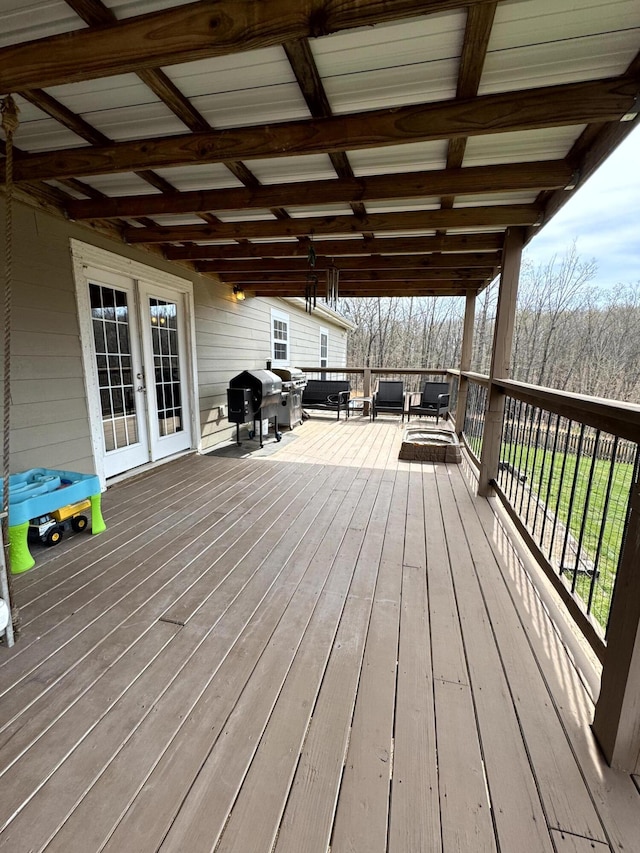 wooden terrace featuring grilling area and french doors
