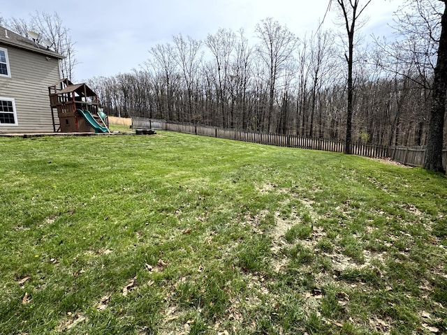 view of yard featuring a fenced backyard and a playground