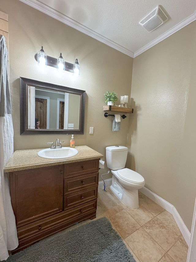 bathroom featuring vanity, baseboards, crown molding, toilet, and visible vents