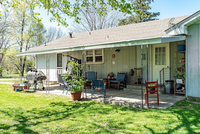133 Sutherland Ave, Mountain Grove, MO 65711 - rear view of property featuring board and batten siding, a patio area, a lawn, and a shingled roof