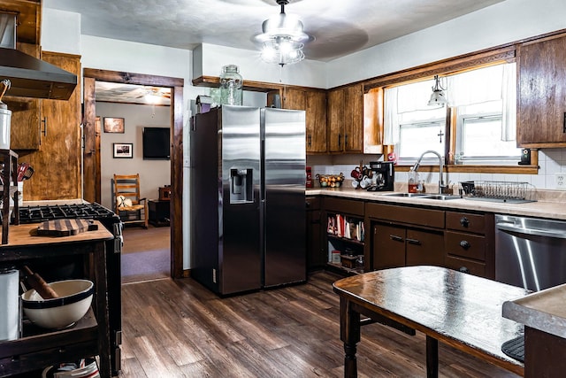 133 Sutherland Ave, Mountain Grove, MO 65711 - kitchen with a sink, ceiling fan, stainless steel appliances, light countertops, and wall chimney exhaust hood