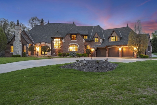 845 W Farm Road 96, Springfield, MO 65803 - french country inspired facade featuring a garage, brick siding, a front lawn, and curved driveway