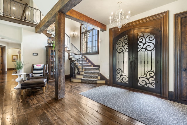 845 W Farm Road 96, Springfield, MO 65803 - foyer entrance featuring french doors, arched walkways, a chandelier, stairway, and wood-type flooring