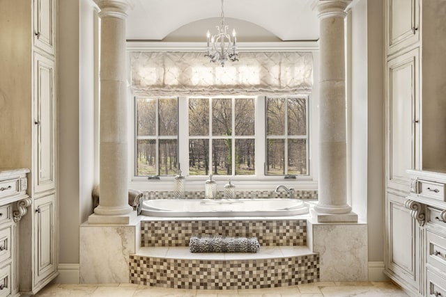 845 W Farm Road 96, Springfield, MO 65803 - bathroom with a bath, baseboards, a notable chandelier, and ornate columns