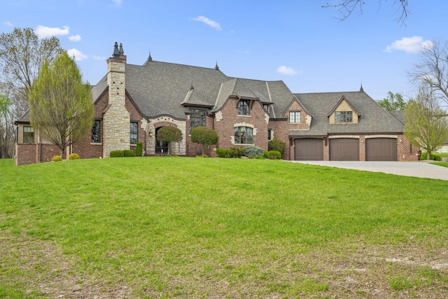 845 W Farm Road 96, Springfield, MO 65803 - french country style house with a chimney, brick siding, a front yard, and concrete driveway