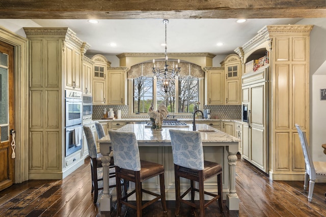 845 W Farm Road 96, Springfield, MO 65803 - kitchen with cream cabinets, paneled refrigerator, dark wood-style flooring, and stainless steel double oven