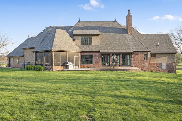 845 W Farm Road 96, Springfield, MO 65803 - rear view of house with a chimney, central air condition unit, a lawn, a shingled roof, and a sunroom