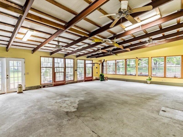 unfurnished sunroom with french doors, beamed ceiling, and plenty of natural light